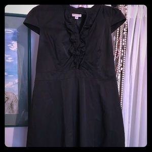 Black cap sleeve ruffle dress. Knee length
